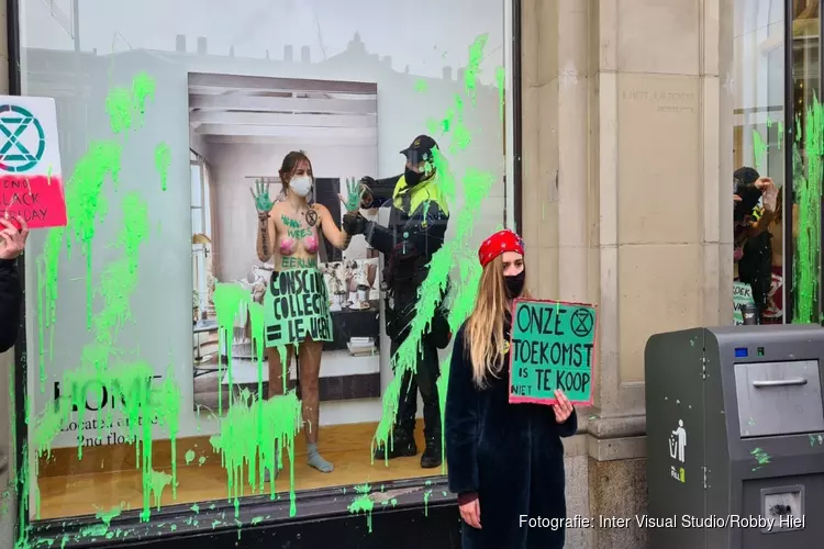 Demonstranten Extinction Rebellion bekladden H&M en gebruiken etalage