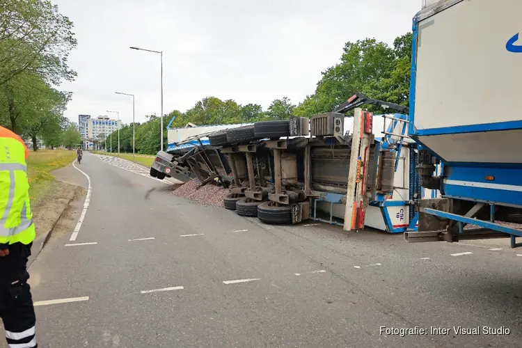 Vrachtwagen met grind kantelt in Amsterdam